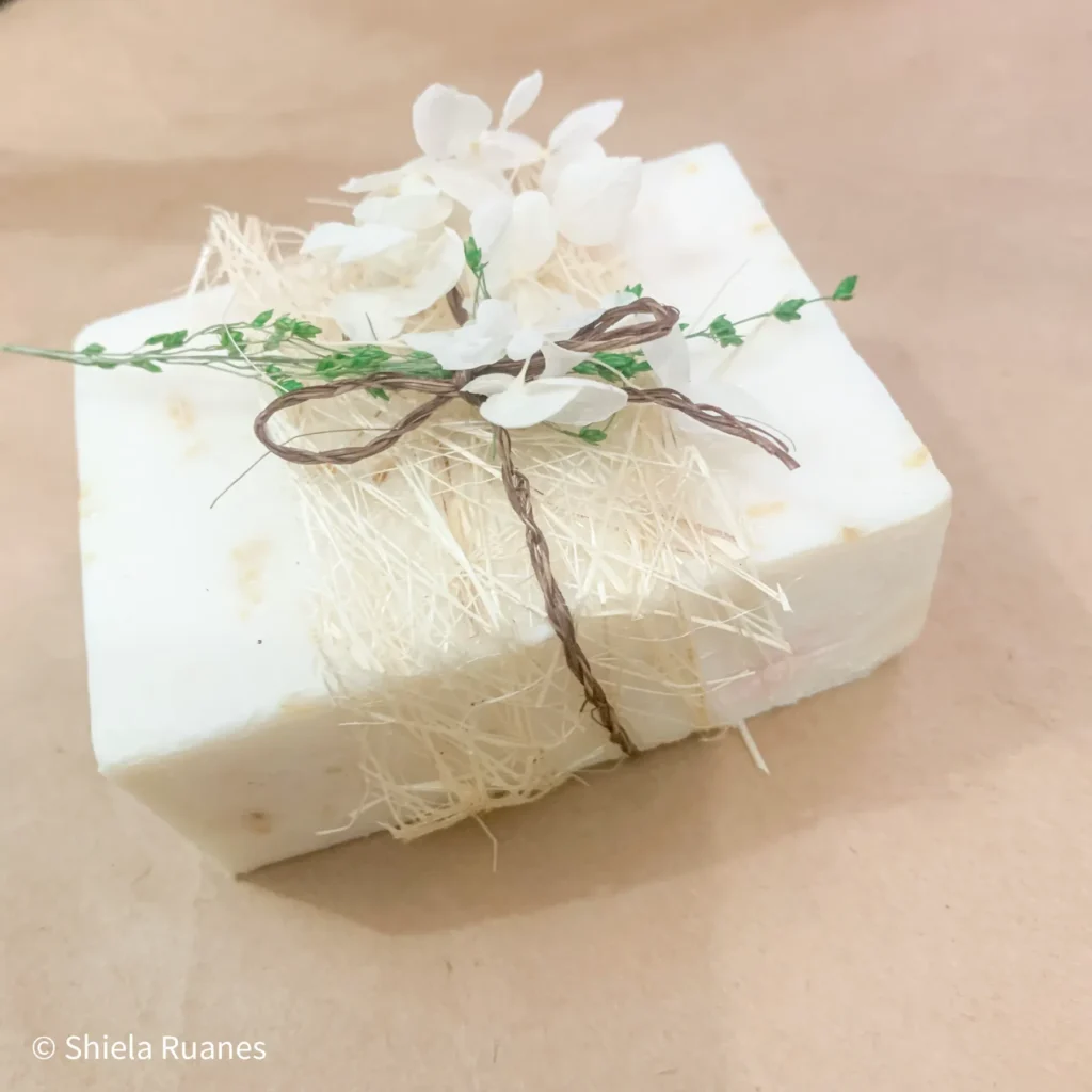 White oatmeal soap decorated with dried flowers and twine